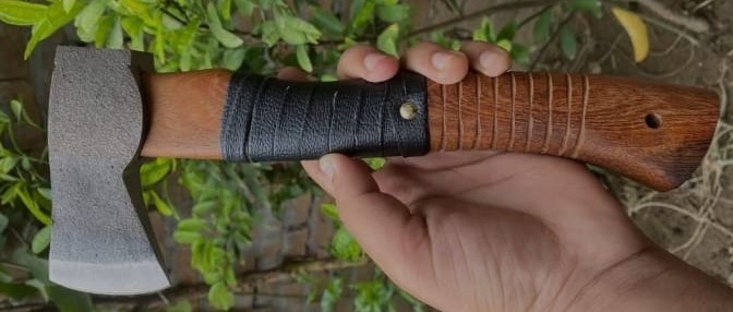 Pair of Viking axes with spiked polls, carved Norse knotwork handles and studded leather grips, in a wooden presentation box