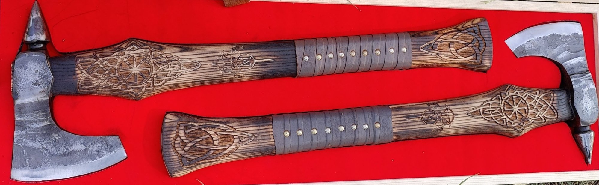 Pair of Viking axes with spiked polls, carved Norse knotwork handles and studded leather grips, in a wooden presentation box